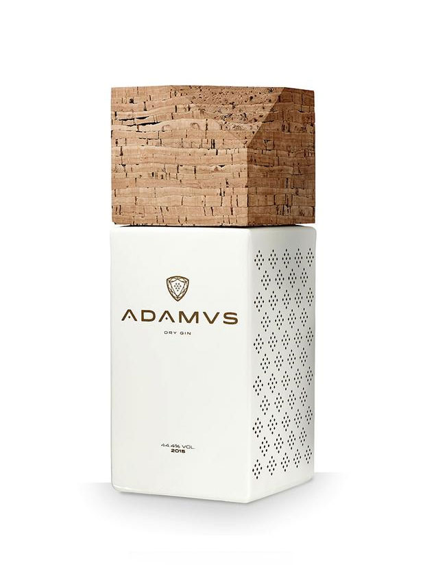 Adamvs Dry Gin bottle with a large cork stopper on top and a white, perforated body against a white background, featuring a gold logo.